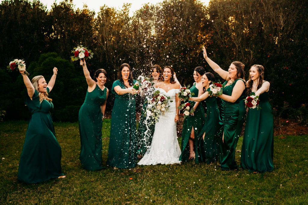 Wedding day champagne pop shot at Rip Van Winkle Gardens for a Louisiana Wedding