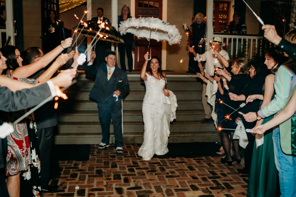 Wedding day reception party photos at Rip Van Winkle Gardens for a Louisiana Wedding featuring a second line sparkler grand exit